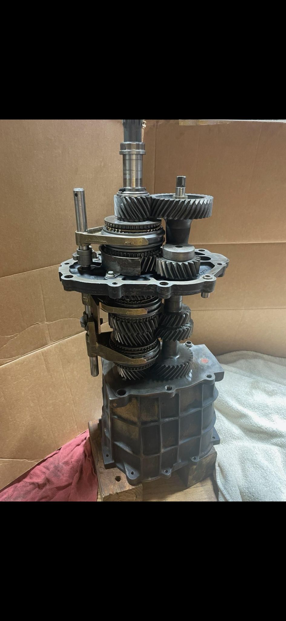 Silver transfer case and transmission housings on a dolly